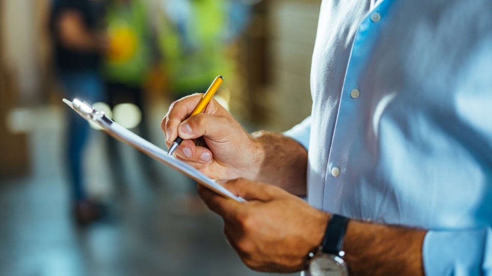 business man writing on a clipboard