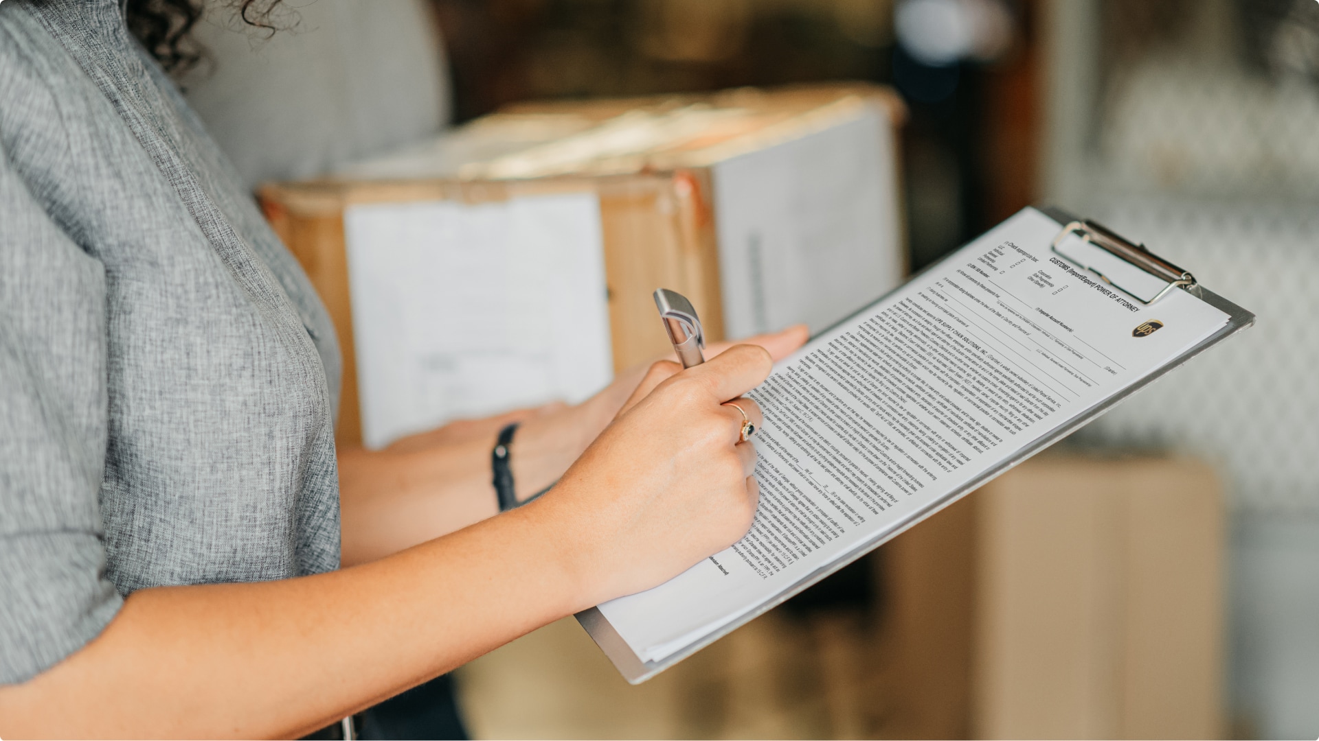 woman filling out a POA form on a clipboard