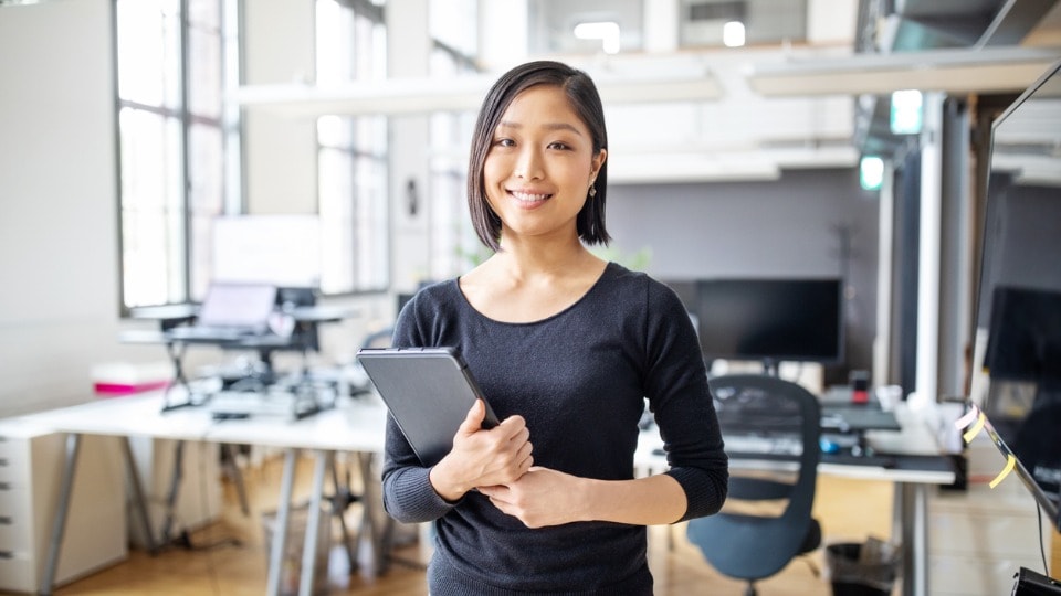 Confident businesswoman standing in office