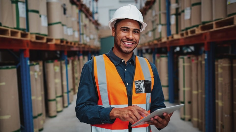 manager using digital tablet in warehouse