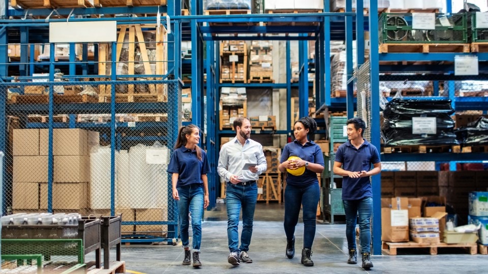 Warehouse employees walking through aisle