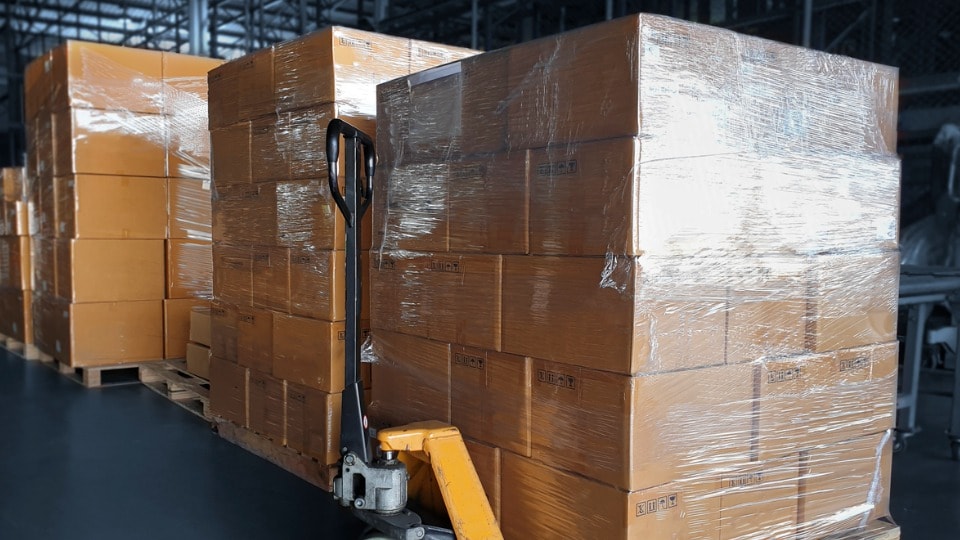 Palletized freight on a hand truck in a warehouse