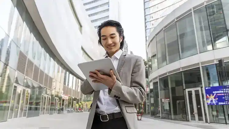 Business man tracks international shipments on his laptop.